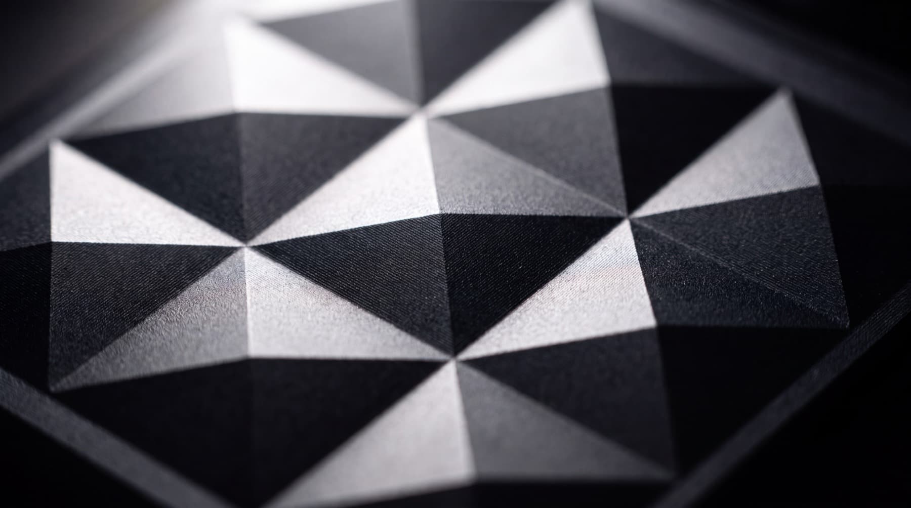 The faceted, diamond-cut surface of chit one Pro, raking across the light.