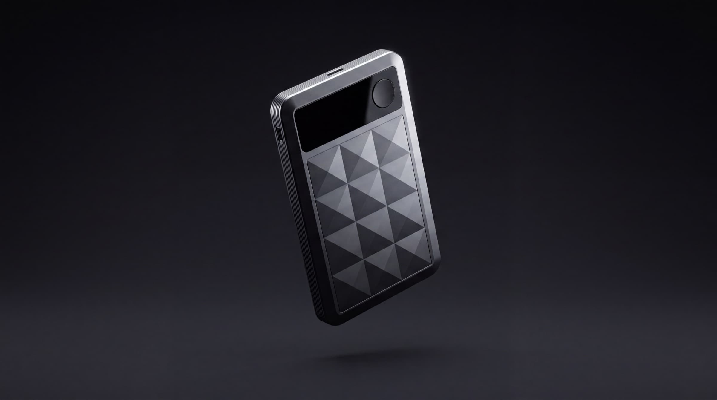 chit one Pro floating on a dark studio stage, its faceted face catching a single overhead light.
